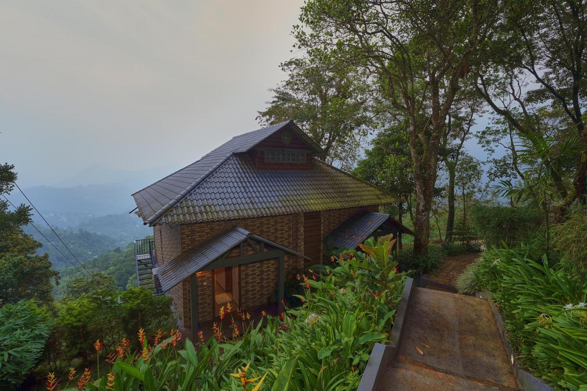 Elephant Passage Munnar Buitenkant foto A cottage at the resort